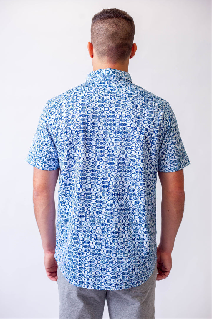 Buki's short sleeve tech shirt blue patterned shirt against a white background