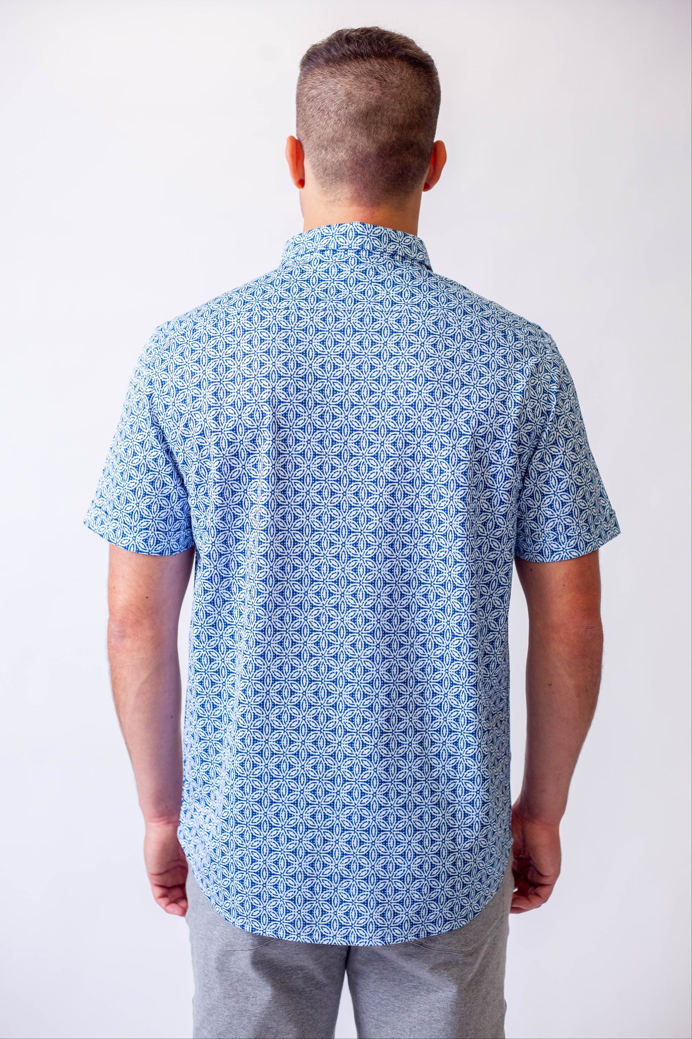 Buki's short sleeve tech shirt blue patterned shirt against a white background