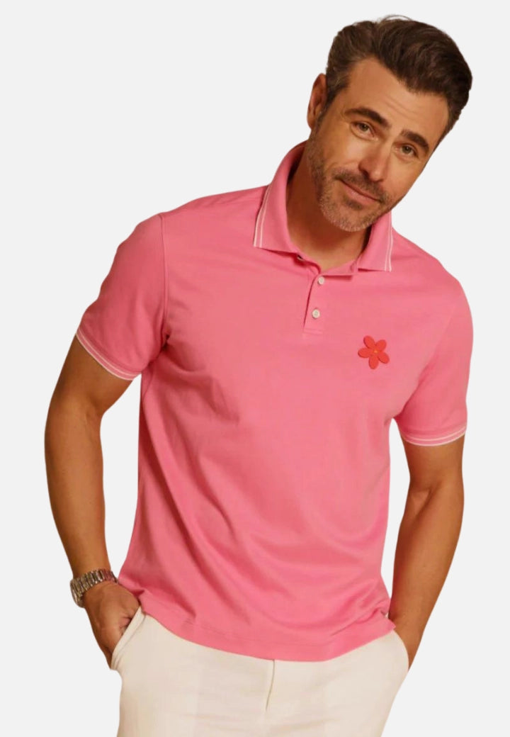 Made in Thailand, this Buki "happy" polo shirt features a "happy" flower motif on the chest. In Sunrise.