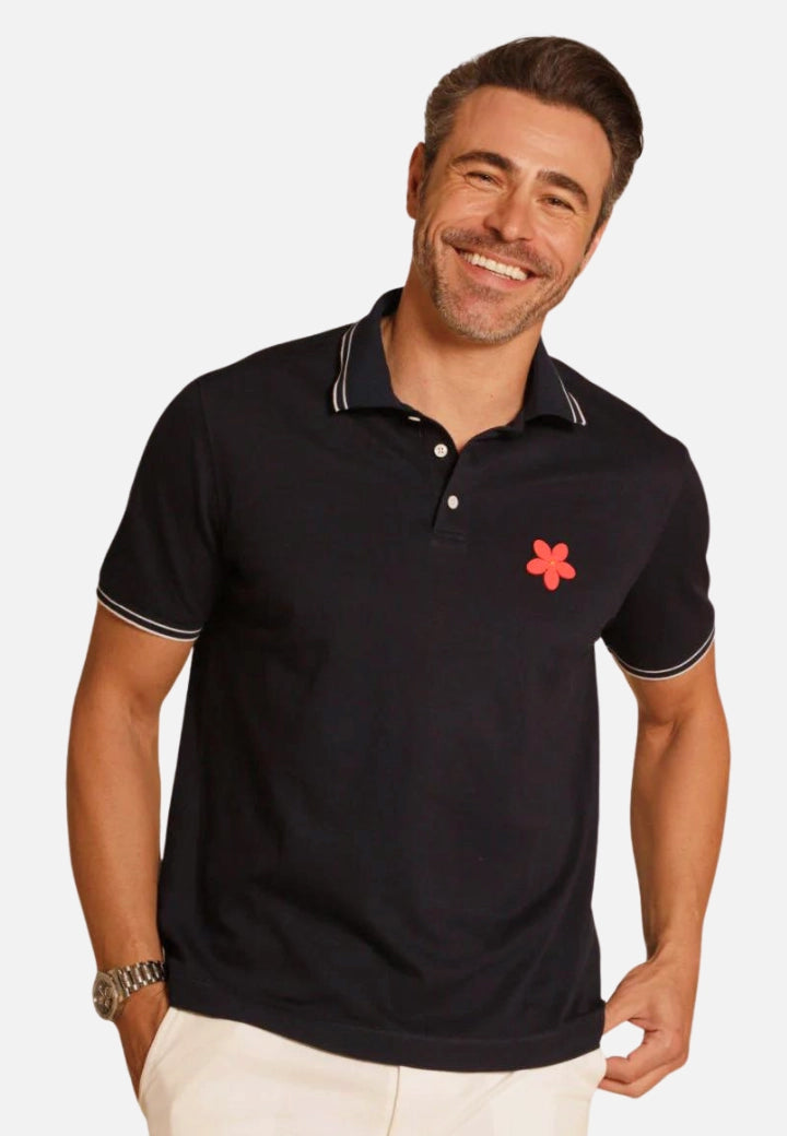 Made in Thailand, this Buki "happy" polo shirt features a "happy" flower motif on the chest. in Navy.