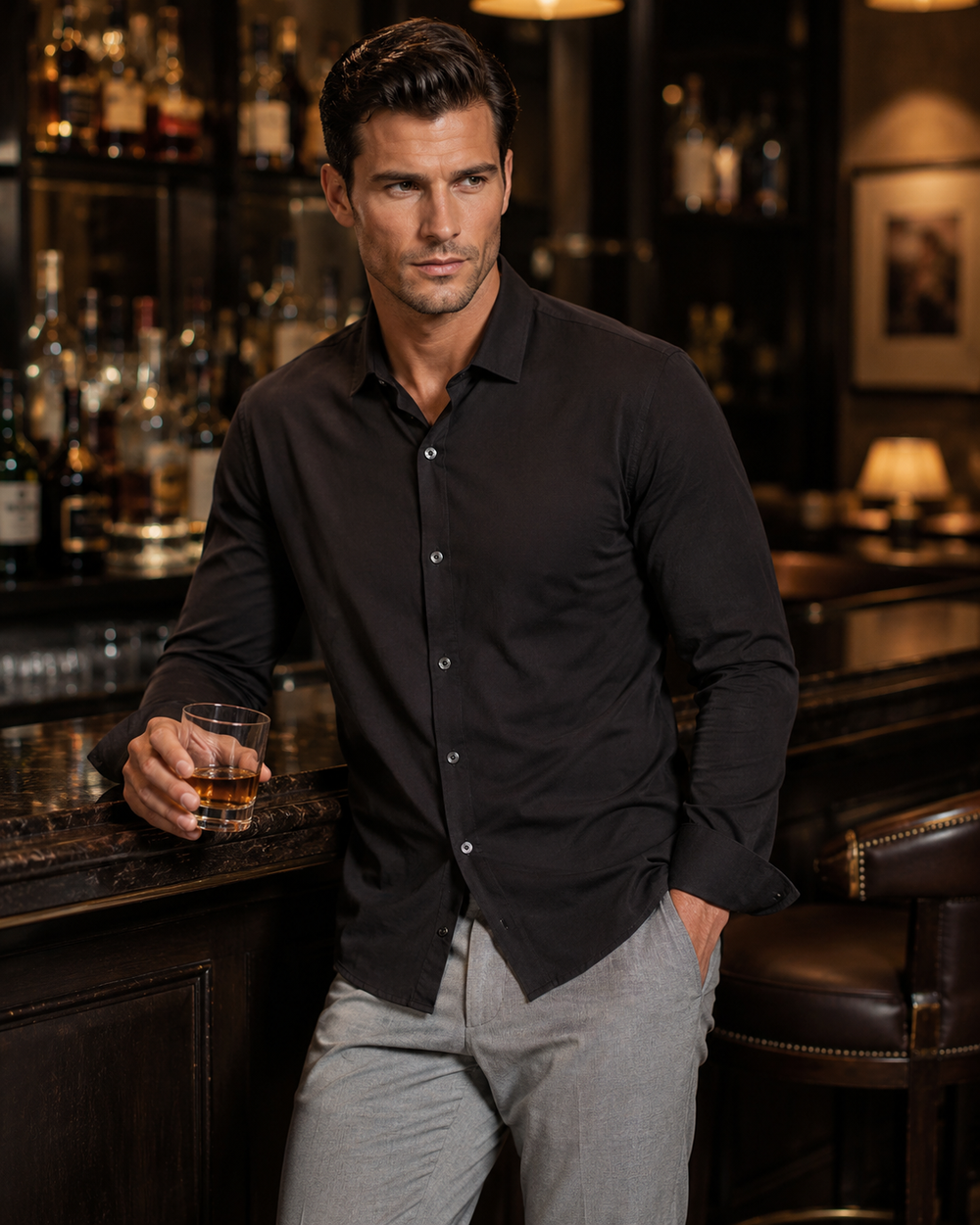 Man in a bar holding a glass of whiskey wearing a Buki Single Shot in Black 