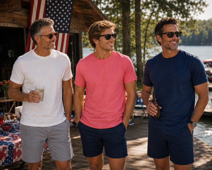 Three men standing on a dock by a lake, wearing sunglasses and Buki Cinqo T-shirts in Slate Rose, White and Navy